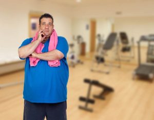 Photo showing a man confused in a gym