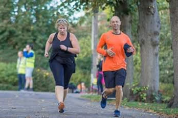 Photo of andy running with a client in the park