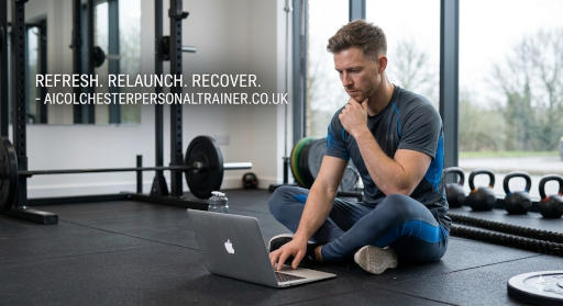 Professional male personal trainer in a gym setting with a laptop representing a website relaunch for AI Colchester Personal Training.